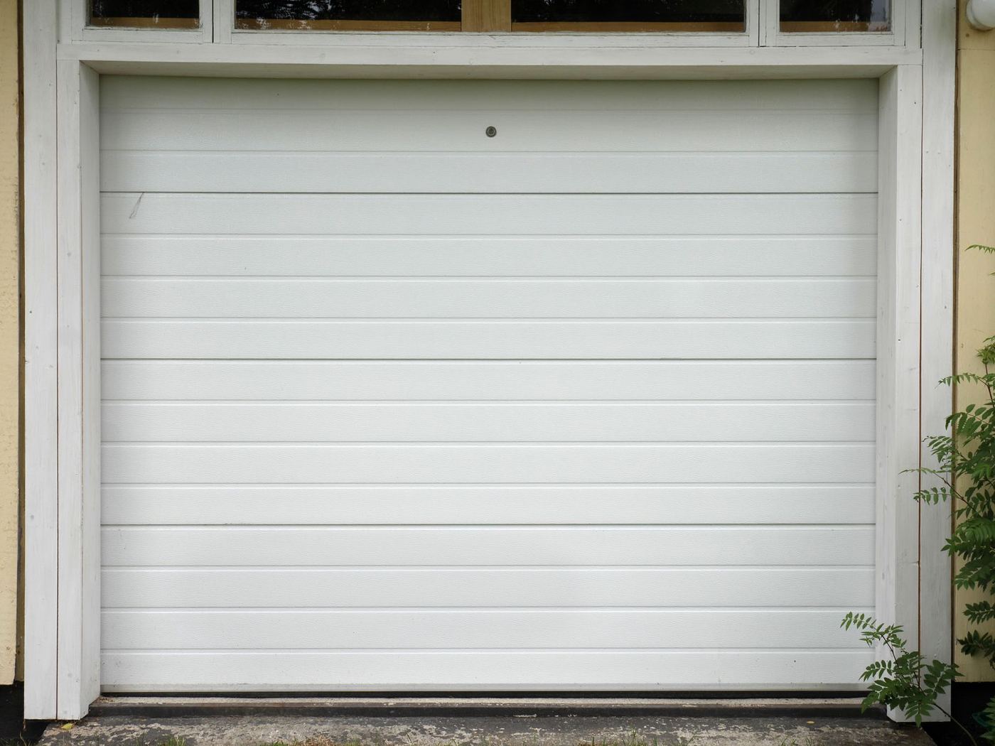 A clean white sectional garage door