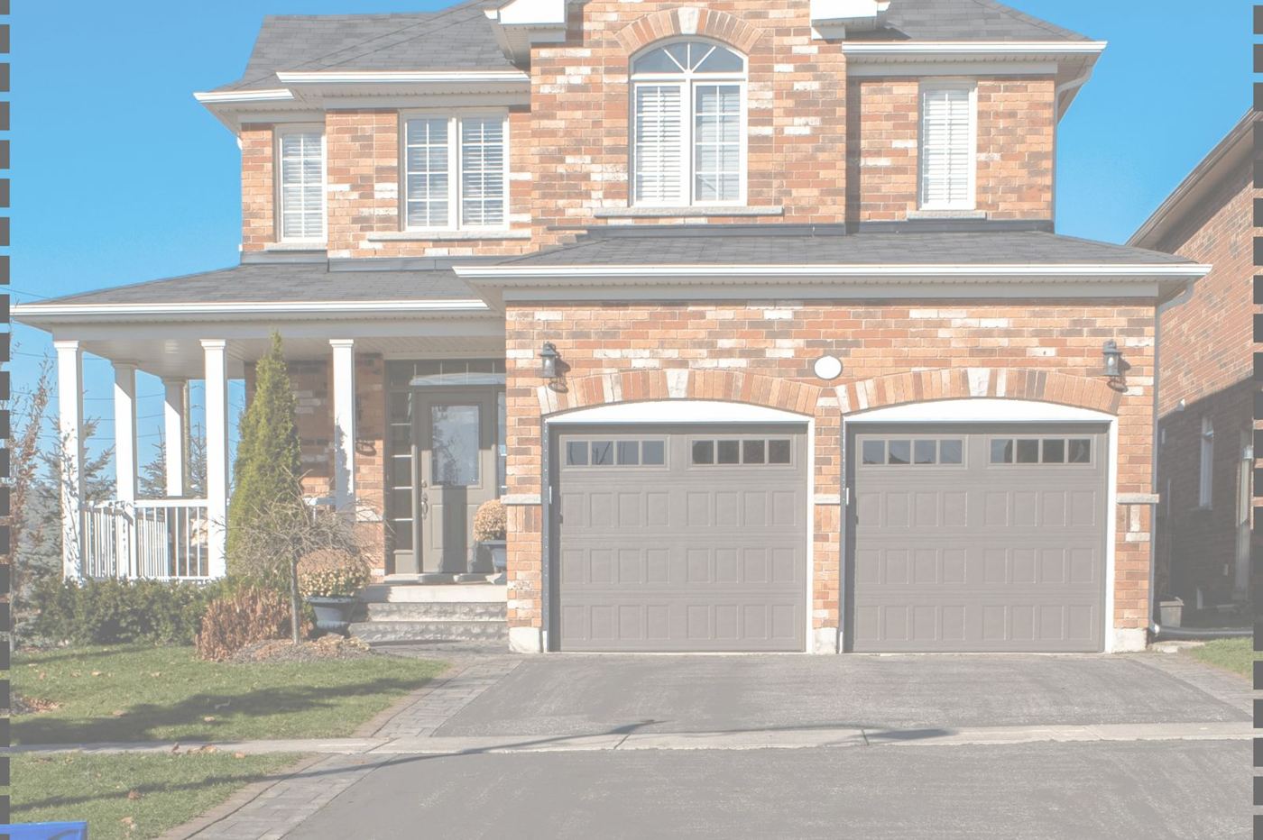 A brick house with double garage doors